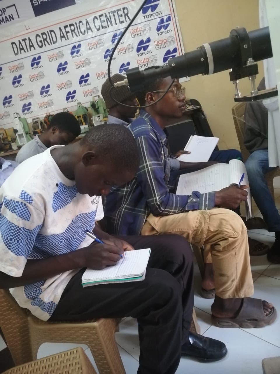 Trainees taking notes during a calibration and GIS orientation